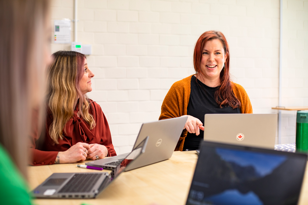 Colleagues work together in a meeting.