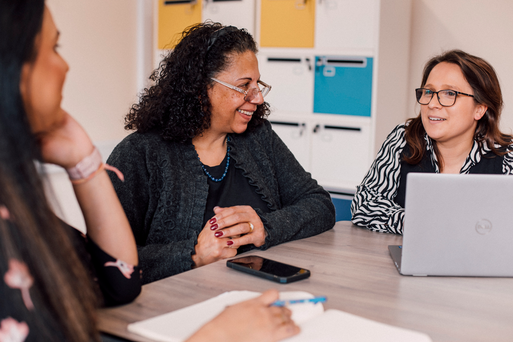 Social work colleagues sit around a table