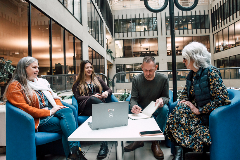 Colleagues having a casual meeting together whilst sitting